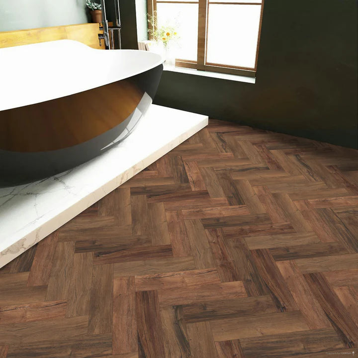 Chicory Haze small plank Herringbone LVT with brown and dark tones and a micro bevel edge.