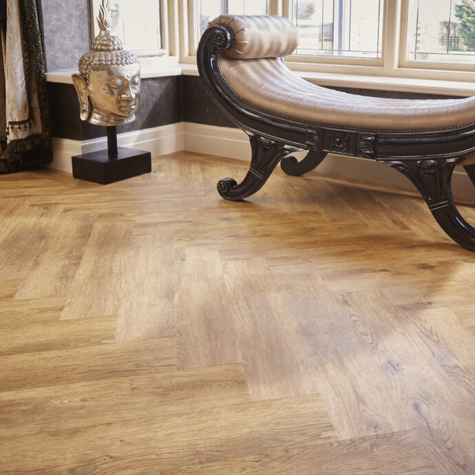 Carpenters Oak Parquet herringbone luxury vinyl tile flooring in warm oak tones, part of the Natural Timbers Parquet collection.