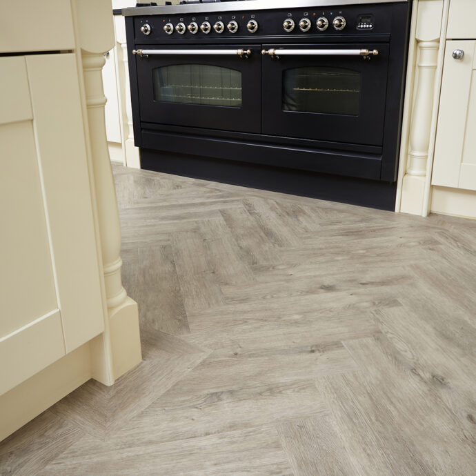 Glue-down Fumed Oak Light Parquet herringbone LVT flooring, offering elegance and practicality for high-traffic areas.