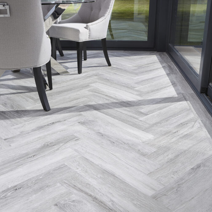 Glacier Oak Parquet herringbone luxury vinyl tile LVT flooring in cool oak tones, part of the Natural Timbers Parquet collection.