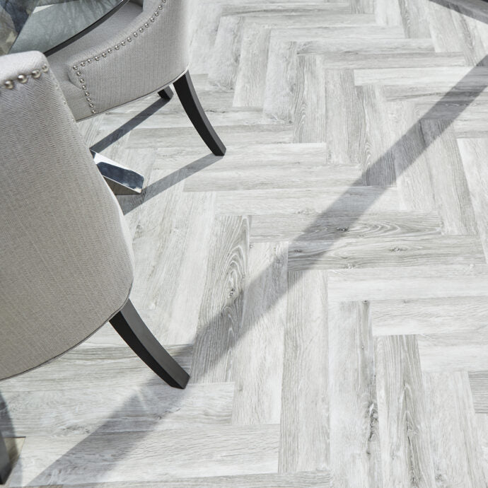 Glue-down Glacier Oak Parquet herringbone LVT flooring, offering contemporary style and long-lasting performance.