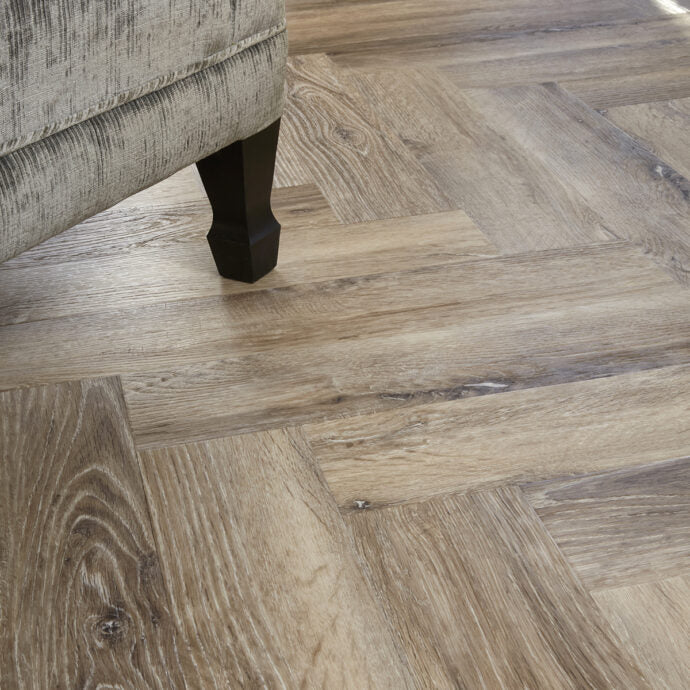 Glue-down Blonde Oak Parquet herringbone LVT flooring, combining style and durability for high-traffic areas.