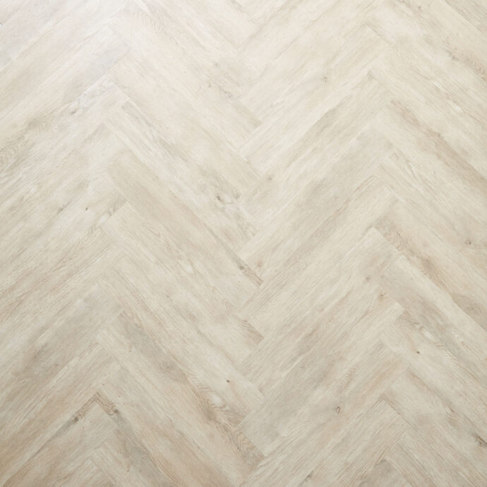 Pale Oak Parquet herringbone luxury vinyl tile LVT flooring in soft oak tones, part of the Natural Timbers Parquet collection.