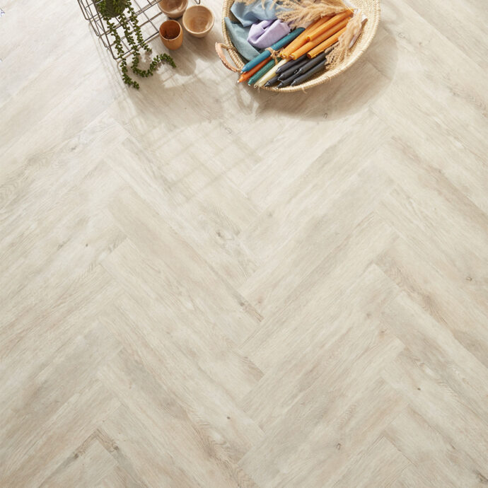 Glue-down Pale Oak Parquet herringbone luxury vinyl tile LVT flooring, designed for high-traffic areas and elegant interiors.