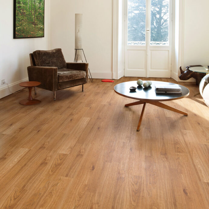 Close-up of Golden Oak LVT planks by AClass Flooring – durable and scratch-resistant luxury vinyl flooring with a secure glue-down installation.