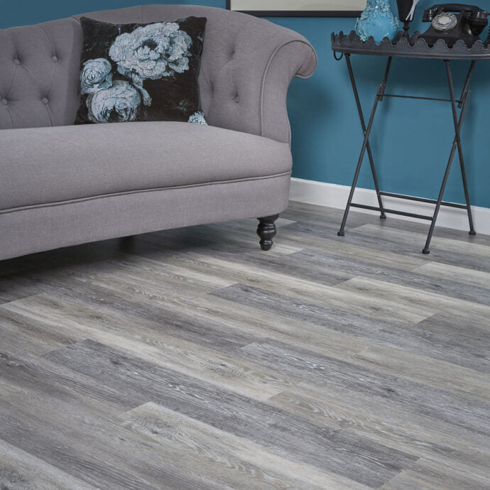 Close-up of Grey Driftwood LVT planks by AClass Flooring – durable, water-resistant glue-down luxury vinyl flooring with a textured wood-effect design.