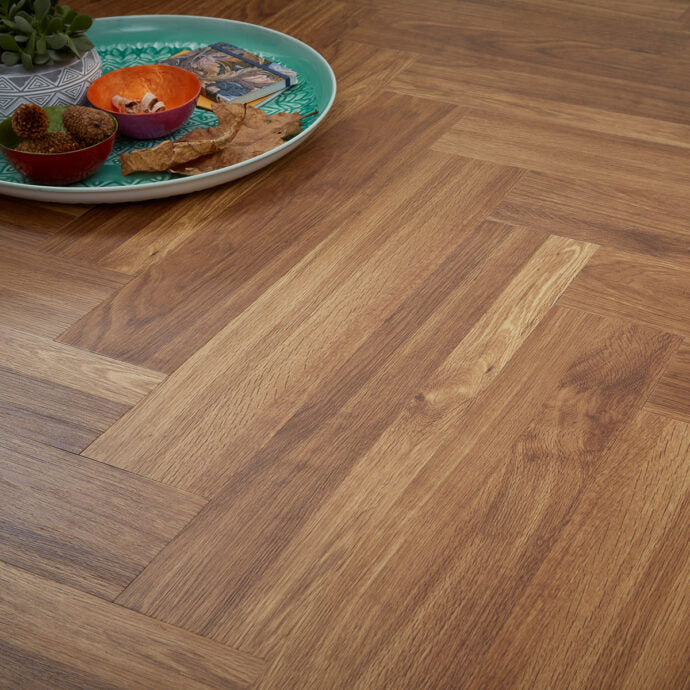 Golden Oak Parquet LVT flooring by AClass Flooring – Herringbone style with micro bevel edge, offering a warm and elegant Golden Oak wood effect finish.