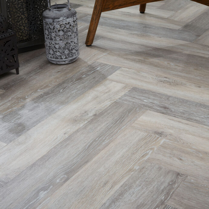 Grey Driftwood Parquet LVT flooring by AClass Flooring – Herringbone style with micro bevel edge, creating a modern and sleek wood effect with neutral grey tones.