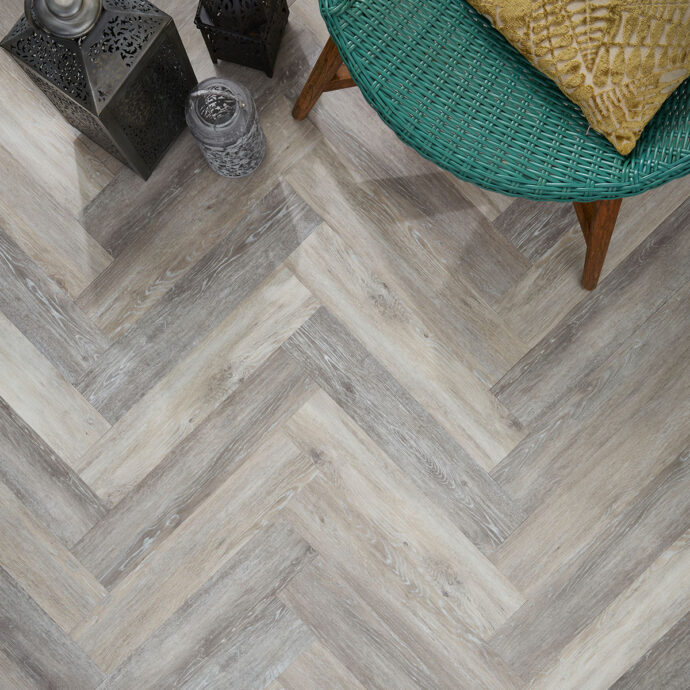 Close-up of Grey Driftwood Parquet LVT planks by AClass Flooring – Durable, water-resistant herringbone LVT with a micro bevel edge and contemporary grey driftwood finish.