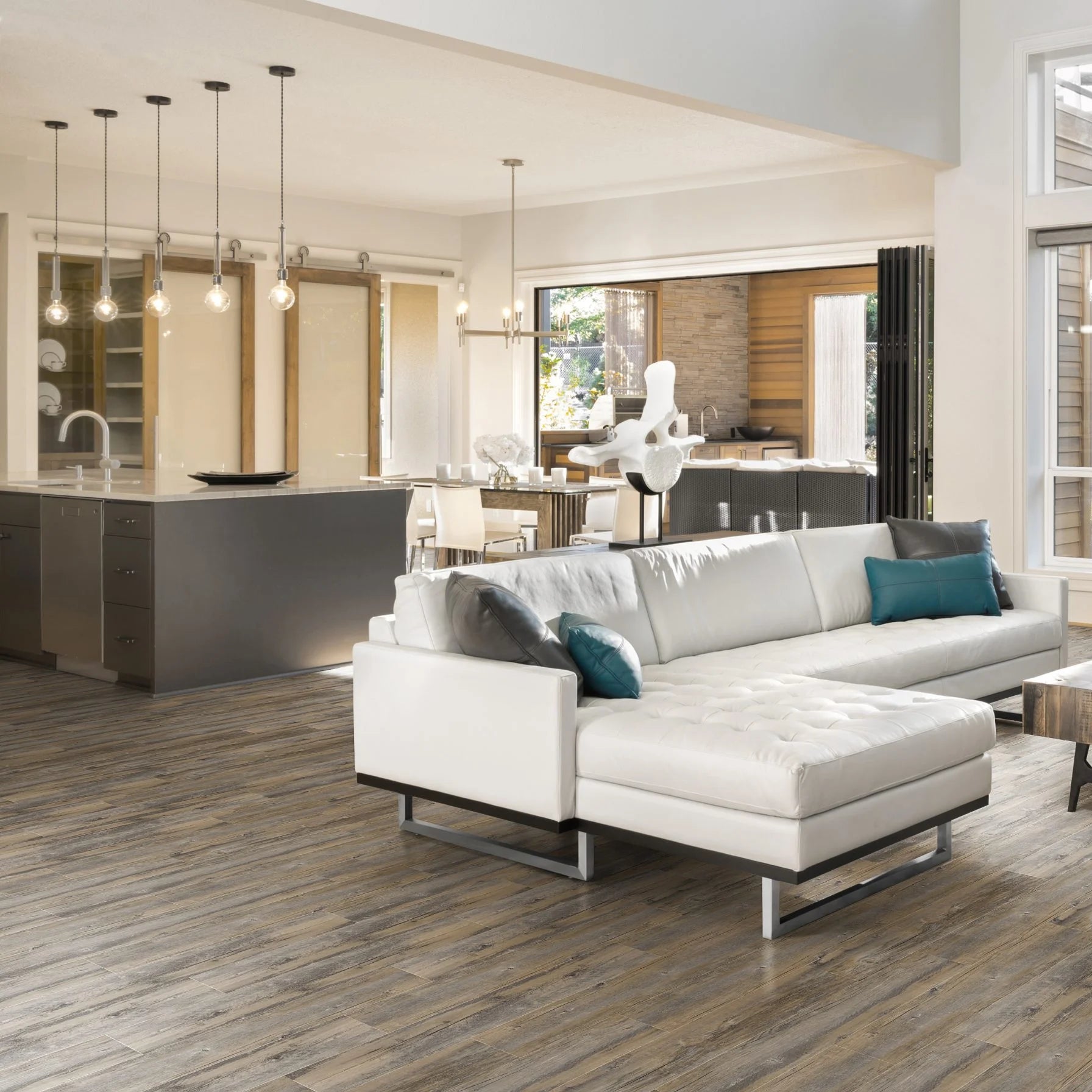 Luvanto Design Wood Plank flooring in Sun Bleached Spruce with light, coastal wood tones in a lounge living room.