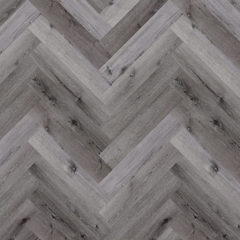 Bodo Herringbone SPC in Winter Oak, featuring warm natural wood tones and a classic herringbone pattern for a cozy, welcoming interior.