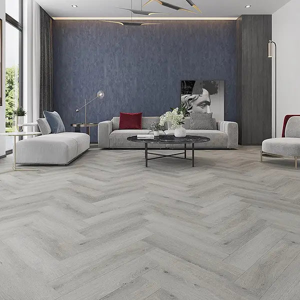 Elegant living room featuring Alva Havana Grey LVT in herringbone design, showcasing contemporary grey tones.