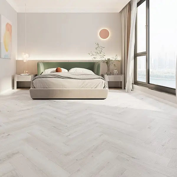 Bedroom featuring Alva Pewter Light Oak LVT in herringbone design, creating a bright and elegant space.