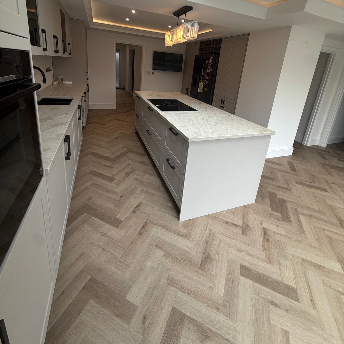 Ravello light oak herringbone LVT installed in modern kitchen