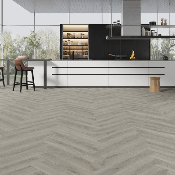 Pebble Shore Herringbone LVT featuring soft beige and grey tones with a micro bevel edge.