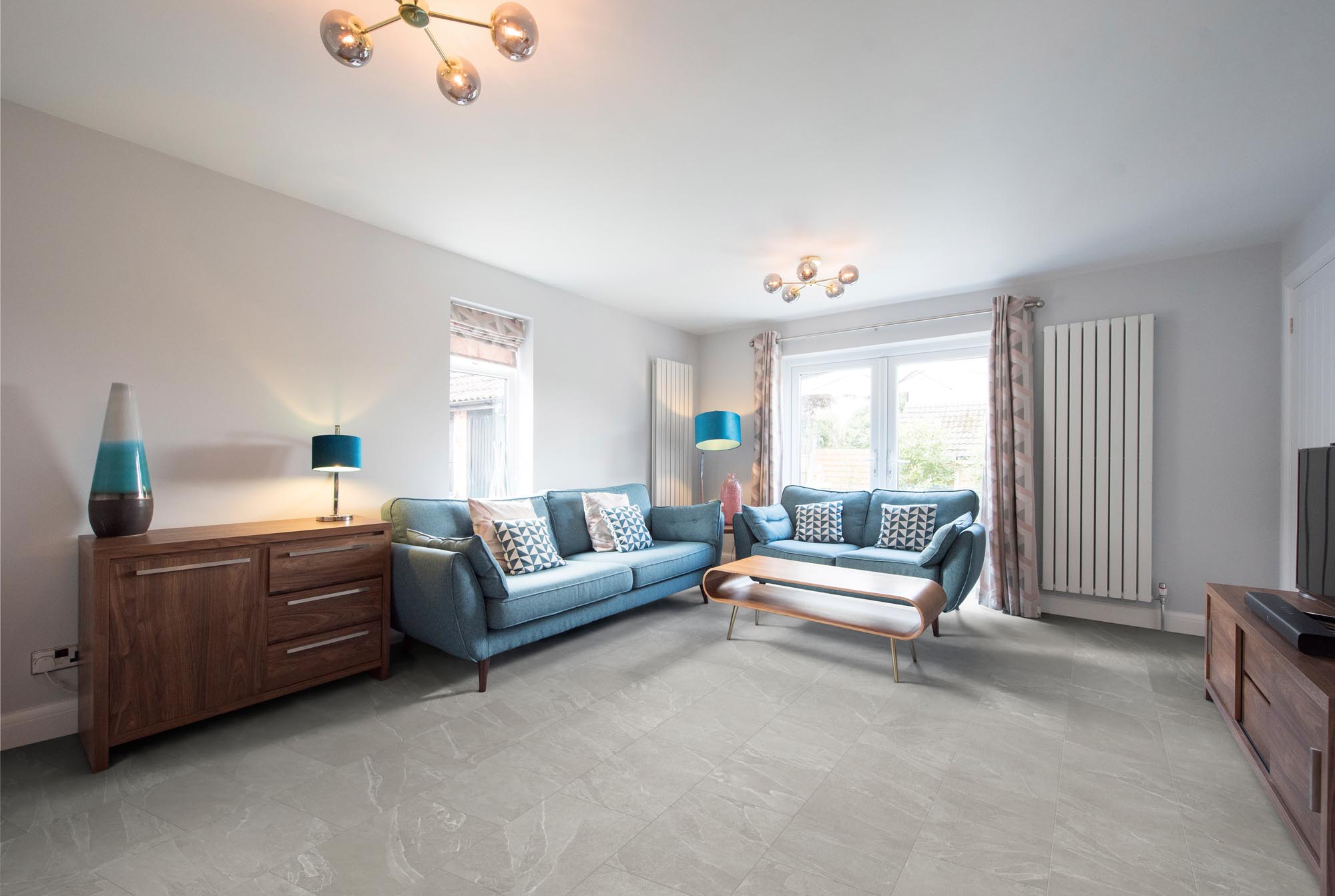 RHINOfloor Evolution LVT in Oxford Pebble Grey, displayed in a stylish living room with soft grey stone effect flooring and modern furnishings.