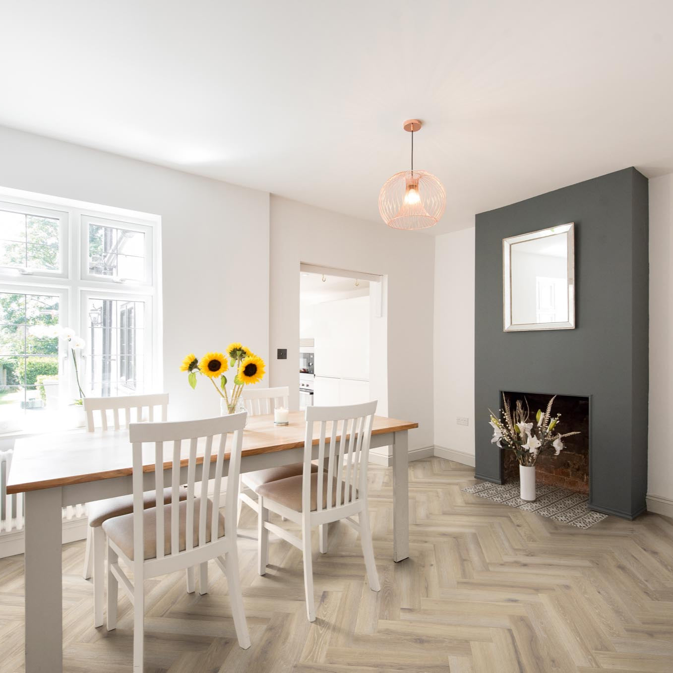 Parquet Norton Grey LVT in a sleek dining room, featuring a sophisticated grey wood effect and herringbone pattern