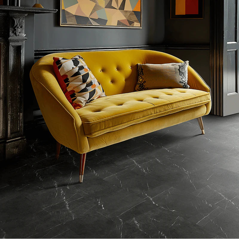 Modern lounge with a yellow sofa showcasing Brampton Chase Carrera Black Stones Marble LVT flooring.