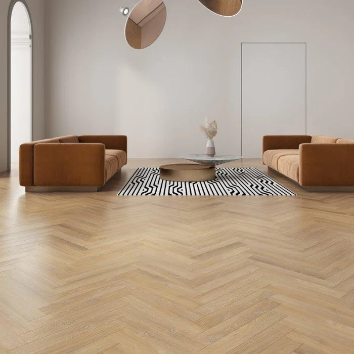 Luxurious herringbone laminate flooring in a rich wood-effect finish, showcasing a warm and inviting interior.