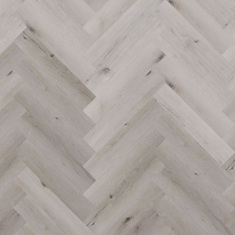 Bodo Herringbone SPC in White Maple, featuring soft, creamy tones and a classic herringbone pattern for a bright and inviting interior.