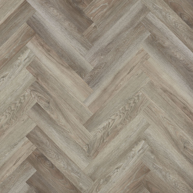 Bodo Herringbone SPC in Limed Oak, showcasing light, muted tones and a classic herringbone pattern for elegant and versatile interiors.

