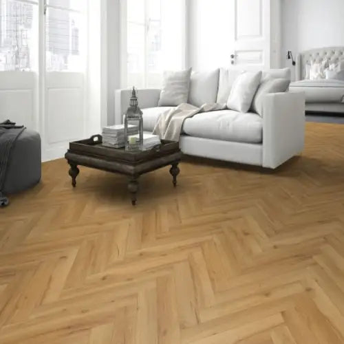 Premium 12mm Herringbone Laminate in Cedar Oak, showcasing a stylish wooden design in a living room setting.