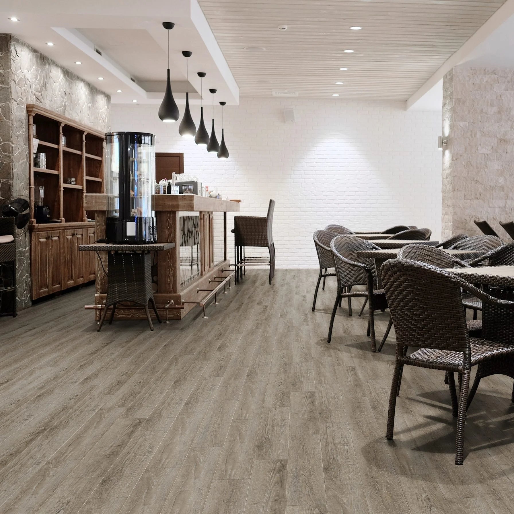 Luvanto Design Wood Plank flooring in Reclaimed Oak with warm, weathered wood tones. In a commercial cafe space