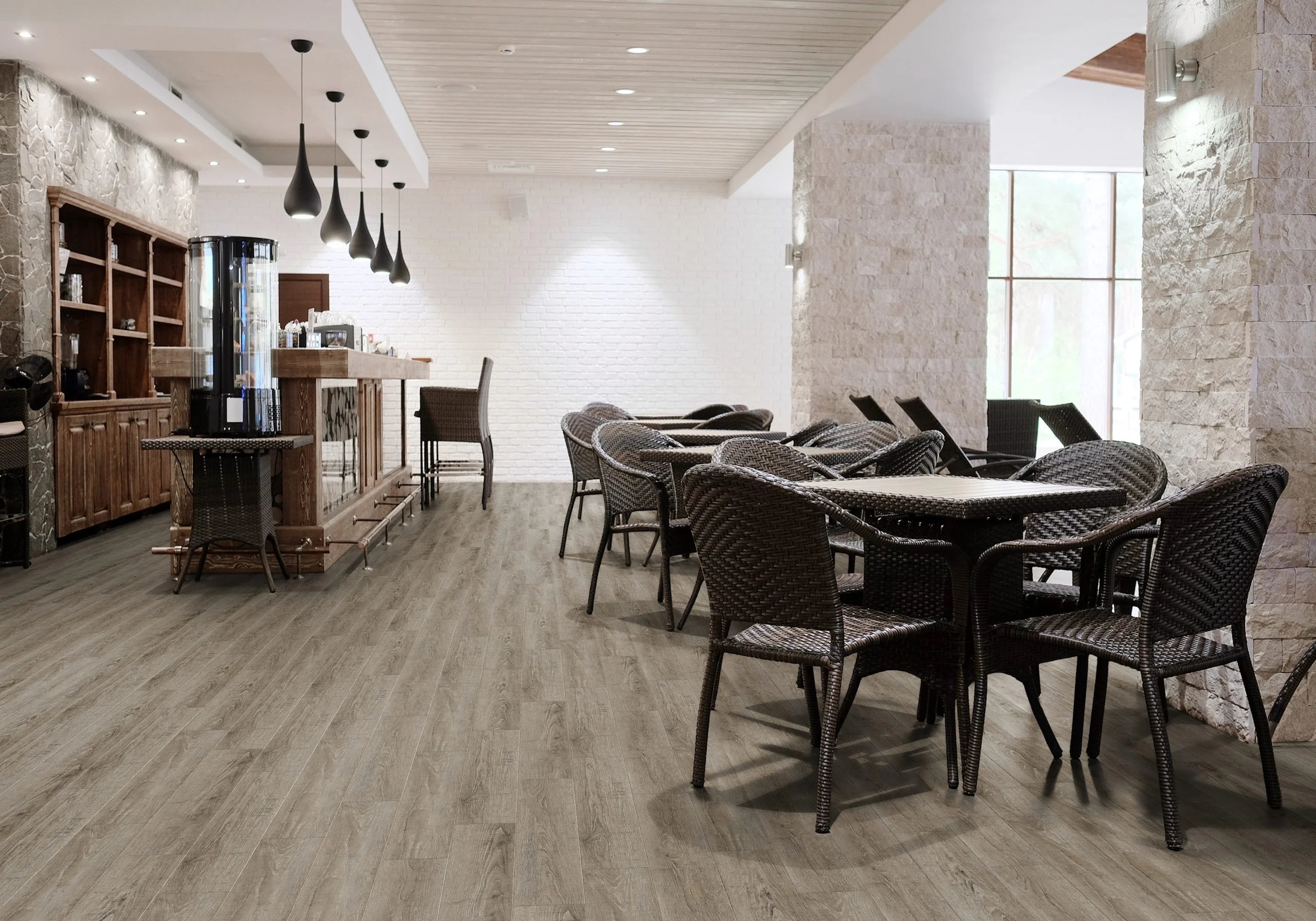 Luvanto Design Wood Plank flooring in Reclaimed Oak with warm, weathered wood tones. In a commercial cafe space