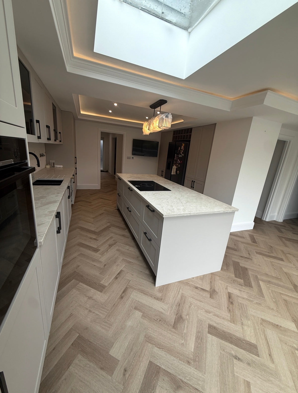 Ravello light oak herringbone LVT installed in modern kitchen
