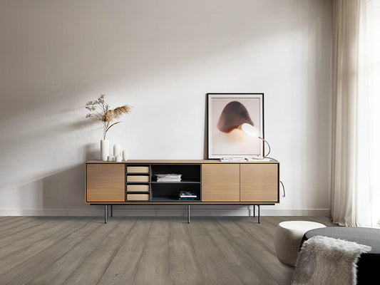 oak coloured laminate flooring in a living room with a sideboard.
